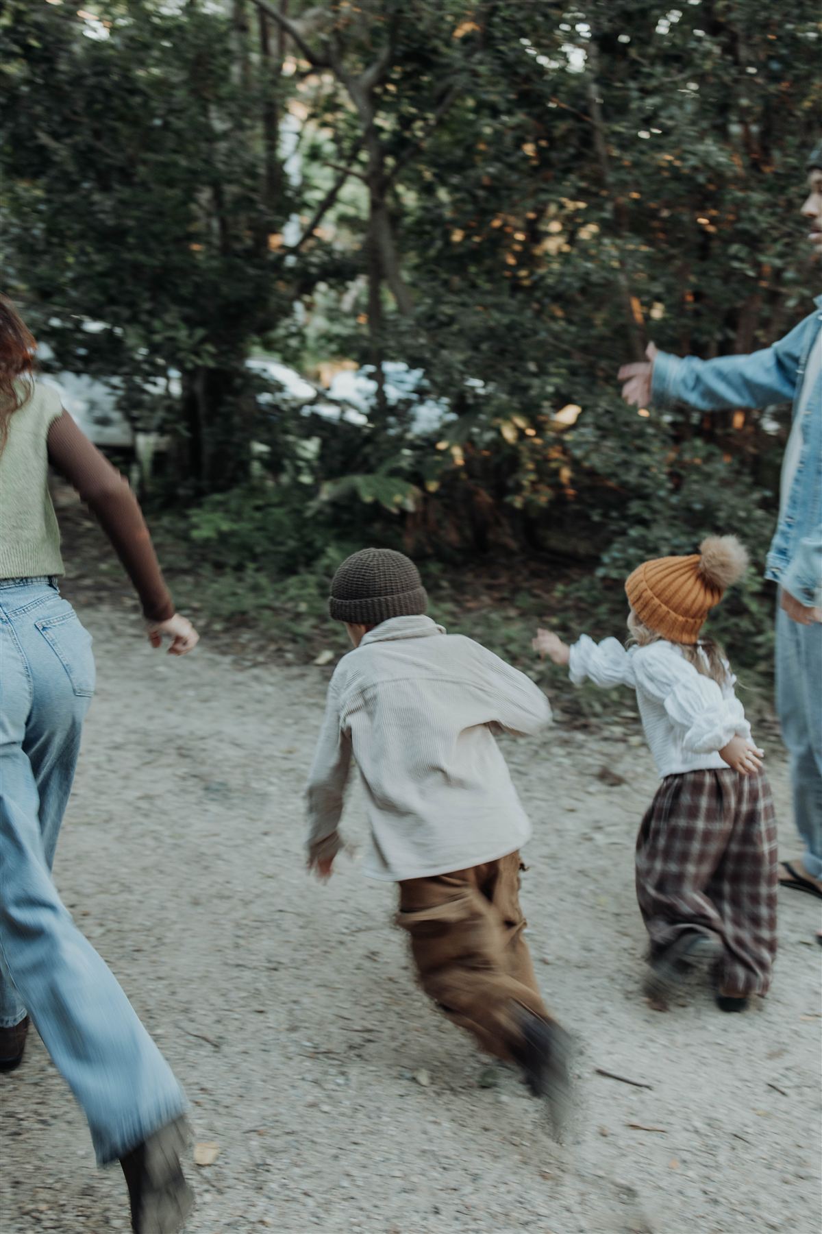 Children running and playing on a forest path, full of motion