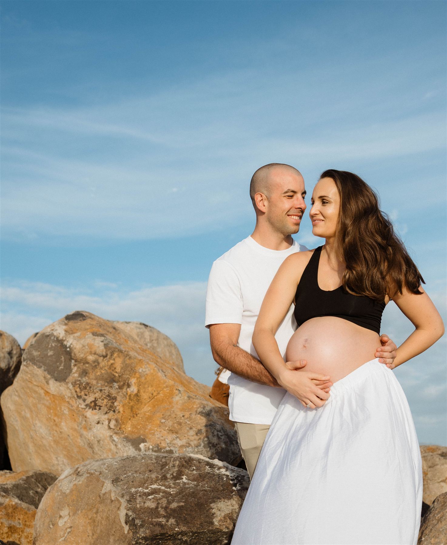 Maternity session on the beach — mother-to-be in golden light